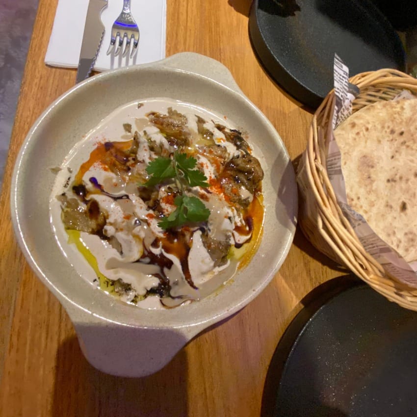 Grilled aubergine (eggplant) with tahini, coriander and lemon. Served with warmed pita