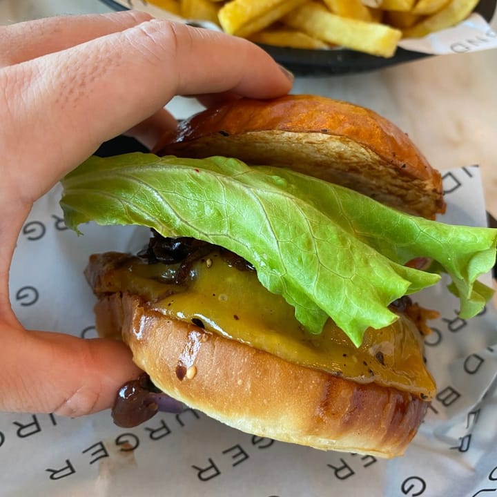 Close-up of the signature Ground Burger with its perfectly stacked ingredients
