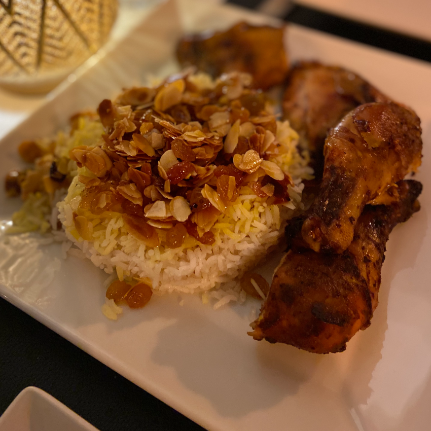 Nutty Persian rice served with almonds and raisins with grilled chicken