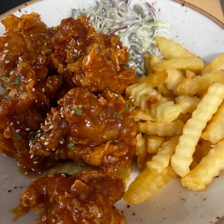 An epic plate of Korean fried chicken, french fries and slaw